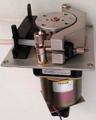 Pump head with attached motor and optical encoder.
